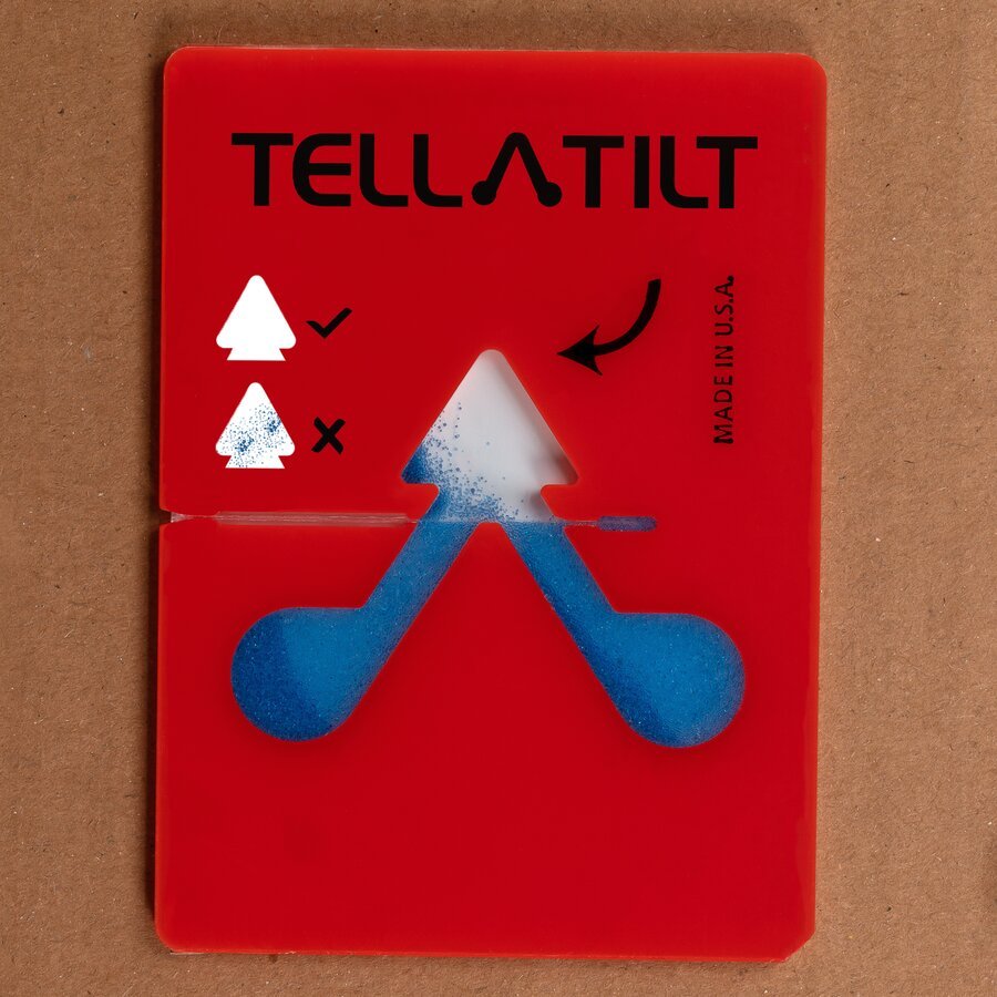 Paket mit Kippindikator wird zurück geneigt Paket mit Kippindikator wird zurück geneigt - Kügelchen bleiben im Klebebereich haften